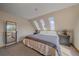 This bedroom features a cozy carpet, neutral paint, and windows that provide views of the mountains and beautiful landscape at 10390 Hondah Dr, Littleton, CO 80127