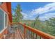 Outdoor seating on this deck offers a beautiful view of the rolling green hills and blue skies of this landscape at 10390 Hondah Dr, Littleton, CO 80127