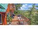 Beautiful outdoor deck with mountain views, lounge seating, dining area, and railing at 10390 Hondah Dr, Littleton, CO 80127