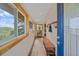 Cozy entryway featuring tile floors, coat hooks, a storage bench, and natural light from a window at 10390 Hondah Dr, Littleton, CO 80127