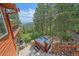 A beautiful redwood hot tub is perfectly nestled in the lush green landscape of this attractive mountain home at 10390 Hondah Dr, Littleton, CO 80127