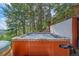 The hot tub's redwood exterior is set among the trees, providing views and natural beauty to this mountain home at 10390 Hondah Dr, Littleton, CO 80127