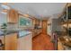Bright and airy kitchen with wooden cabinets, granite countertops, stainless steel appliances, and a rustic charm at 10390 Hondah Dr, Littleton, CO 80127