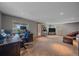 Spacious living area featuring neutral-toned walls and carpet, office space, and natural light at 10390 Hondah Dr, Littleton, CO 80127