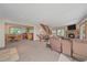 Spacious living room featuring a stone fireplace, staircase, and open access to the dining and kitchen area at 10390 Hondah Dr, Littleton, CO 80127