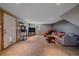 Comfortable living room setup with a gray couch, TV, and doorway with a pet door at 10390 Hondah Dr, Littleton, CO 80127