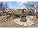 Inviting backyard with pergola, fire pit, and quaint landscaping, perfect for outdoor gatherings at 9551 W 38Th Ave, Wheat Ridge, CO 80033