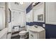 This bathroom features a modern white vanity, classic framed mirror, and a shower with white tiling and curtain at 9551 W 38Th Ave, Wheat Ridge, CO 80033