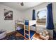 bedroom featuring a bunk bed, hardwood floors, and large windows at 9551 W 38Th Ave, Wheat Ridge, CO 80033