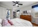 Inviting bedroom with white bedding, wood dresser, and hardwood floors at 9551 W 38Th Ave, Wheat Ridge, CO 80033