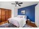 Stylish bedroom with a blue accent wall, hardwood floors, and modern furniture at 9551 W 38Th Ave, Wheat Ridge, CO 80033