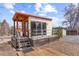 Modern accessory dwelling unit (ADU) features a wooden deck, metal handrails, and glass sliding doors at 9551 W 38Th Ave, Wheat Ridge, CO 80033