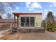 Modern accessory dwelling unit (ADU) features a wooden deck, metal handrails, and glass sliding doors at 9551 W 38Th Ave, Wheat Ridge, CO 80033