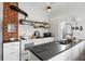 A kitchen with stainless steel appliances, brick chimney, island and open shelving at 9551 W 38Th Ave, Wheat Ridge, CO 80033