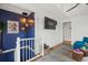 View of living room from the stair landing with modern decor and natural light at 9551 W 38Th Ave, Wheat Ridge, CO 80033