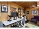 Bright home office with a modern desk, ergonomic chair, wood paneled walls, and lots of shelving for storage at 9551 W 38Th Ave, Wheat Ridge, CO 80033