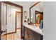 Bathroom with wooden cabinet, quartz countertops, and reflective mirror for a bright, open space at 405 Village Rd # 405, Breckenridge, CO 80424