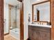 Updated bathroom with wood vanity, modern fixtures, and shower with glass doors at 405 Village Rd # 405, Breckenridge, CO 80424