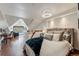 Lofted bedroom boasts sloped ceilings, modern decor, and natural light at 405 Village Rd # 405, Breckenridge, CO 80424