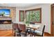 Bright dining room with a wood burning fireplace, large windows, and wood dining table at 405 Village Rd # 405, Breckenridge, CO 80424