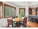 Bright dining room with a wood dining table, a bar top and views of the evergreen trees at 405 Village Rd # 405, Breckenridge, CO 80424