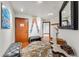 Inviting hallway with hardwood floors, decorative skis, and a view into other living areas at 405 Village Rd # 405, Breckenridge, CO 80424