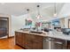 Open-concept kitchen featuring stainless steel appliances and a granite-topped center island at 405 Village Rd # 405, Breckenridge, CO 80424
