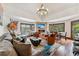 Spacious living room with a stone fireplace, mounted tv and an abundance of natural light at 405 Village Rd # 405, Breckenridge, CO 80424