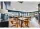Open lounge area with tables, chairs, fireplace and a comfortable setting for social gatherings at 405 Village Rd # 405, Breckenridge, CO 80424
