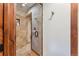Attractive tiled shower features glass door, built-in niche, and updated fixtures at 405 Village Rd # 405, Breckenridge, CO 80424