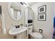 Charming bathroom with a pedestal sink, decorative wall art, and a modern toilet at 1265 Elizabeth St # 305, Denver, CO 80206