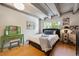 Bedroom featuring wooden floors, a comfortable bed, and a green vanity with a stool at 1265 Elizabeth St # 305, Denver, CO 80206
