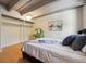 Bedroom with natural wood floors, a bed, and a green vanity near a walk-in closet at 1265 Elizabeth St # 305, Denver, CO 80206