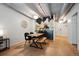 Bright dining area with a table, bench, and chairs, adjacent to the kitchen at 1265 Elizabeth St # 305, Denver, CO 80206