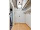 Hallway showcasing wood floors, shelving, and modern lighting fixtures adjacent to the kitchen, maximizing space and style at 1265 Elizabeth St # 305, Denver, CO 80206