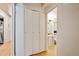 Hallway featuring closet with folding doors leading to a well-lit bathroom with a pedestal sink and tiled floor at 1265 Elizabeth St # 305, Denver, CO 80206