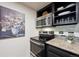 Modern kitchen with stainless steel appliances, granite countertops and tile backsplash at 1265 Elizabeth St # 305, Denver, CO 80206