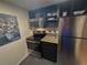 The kitchen features stainless appliances, including microwave and oven, and granite countertops at 1265 Elizabeth St # 305, Denver, CO 80206