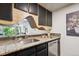 Bright kitchen featuring stainless appliances, granite countertops, and a unique open design at 1265 Elizabeth St # 305, Denver, CO 80206