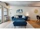 Cozy living area features an accent wall, contemporary decor, and hardwood floors at 1265 Elizabeth St # 305, Denver, CO 80206