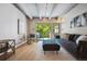 Living area offers neutral walls, modern lighting, wood floors, and natural light at 1265 Elizabeth St # 305, Denver, CO 80206