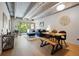 Bright living room boasts exposed concrete beams, hardwood floors, and access to balcony at 1265 Elizabeth St # 305, Denver, CO 80206