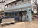 Restaurant exterior with a blue facade, outdoor seating, and 