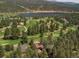 Breathtaking aerial view of the home near a golf course and a pristine lake surrounded by trees at 29090 Golf Way, Evergreen, CO 80439