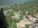 Picturesque aerial view of Evergreen, Colorado, showcasing lush greenery and charming streets at 29090 Golf Way, Evergreen, CO 80439