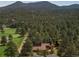 Breathtaking aerial shot of a home surrounded by lush forest and mountains at 29090 Golf Way, Evergreen, CO 80439