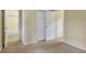 Bedroom showcasing carpeted floors with access to closet and full bathroom at 29090 Golf Way, Evergreen, CO 80439