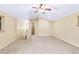 Spacious carpeted bonus room featuring neutral paint, vaulted ceilings and a ceiling fan at 29090 Golf Way, Evergreen, CO 80439