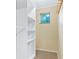 Walk-in closet with custom shelving, carpet flooring, and natural light from a window at 29090 Golf Way, Evergreen, CO 80439