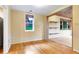 Bright dining room with hardwood floors, large windows, and built-in shelving in a neutral color palette at 29090 Golf Way, Evergreen, CO 80439